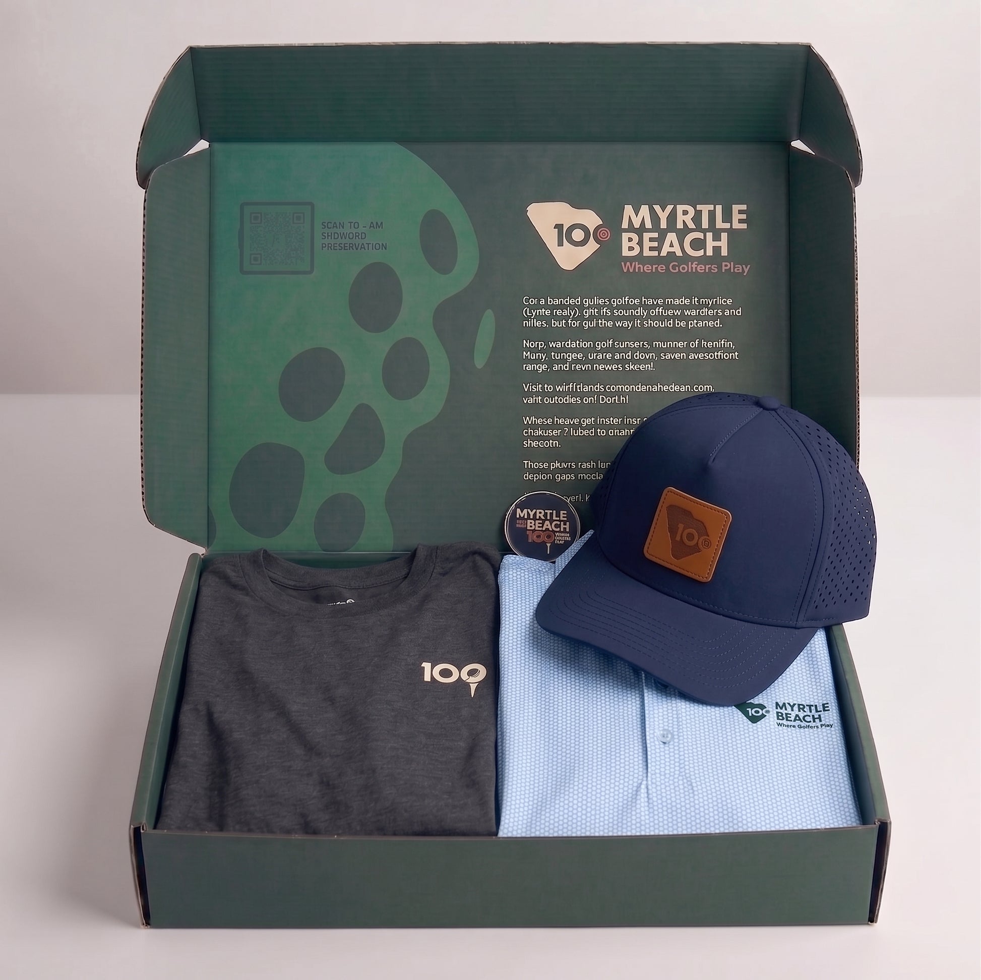 An open dark green gift box containing a folded dark gray t-shirt, a folded light blue polo shirt with a green 'MYRTLE BEACH' logo, and a navy blue baseball cap with a brown leather patch. 