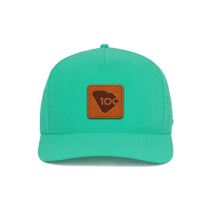 A mint green trucker-style cap with a brown leather patch on the front.