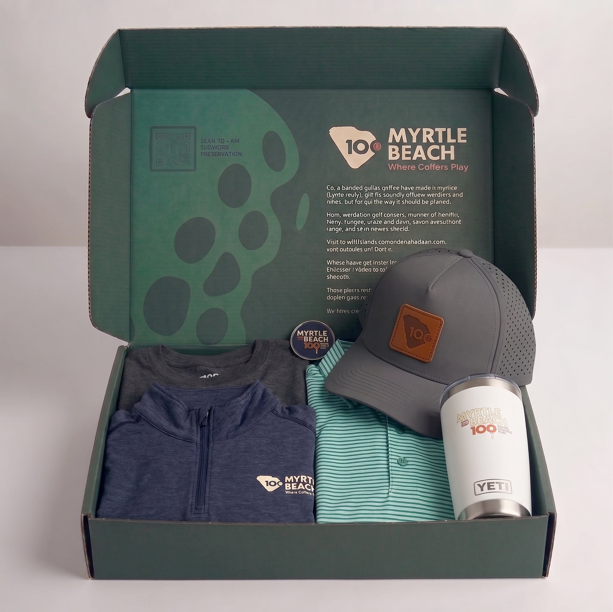 A curated gift box set featuring a navy quarter-zip, a green and white striped polo shirt, a gray baseball cap with a brown logo patch, and a white Yeti tumbler, all neatly arranged inside a dark green branded cardboard box.
