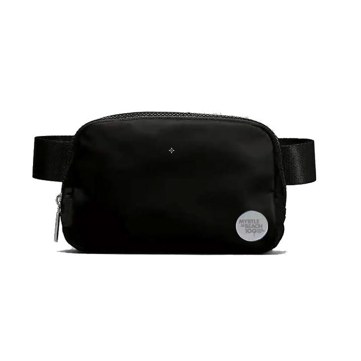 A black nylon waist bag with an adjustable black webbing strap, a top zipper, and a small circular white brand patch on the lower right side.